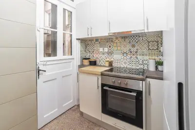 a kitchen with white cabinets and a stove top oven at Athens Imperial Suite 1 in Athens