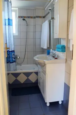 a bathroom with a sink and a toilet and a shower at Helen's Sounio Apartments in Sounio