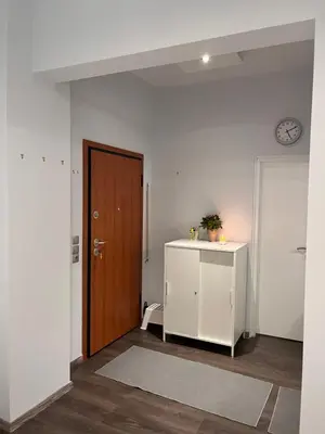 a room with a door and a cabinet and a clock at Studio by Acropolis in Athens