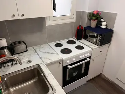 a kitchen with a stove and a microwave at Studio by Acropolis in Athens