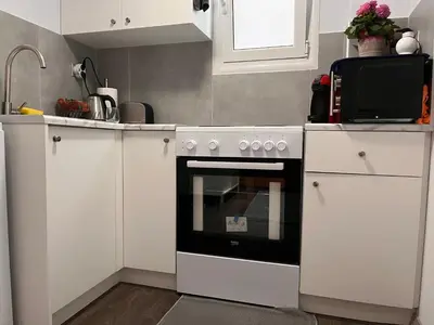 a kitchen with a white stove and a microwave at Studio by Acropolis in Athens