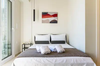 a bedroom with a bed with two pillows on it at Buena Vista by Pame Rentals in Piraeus