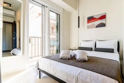 a bedroom with a large bed with two pillows on it at Buena Vista by Pame Rentals in Piraeus
