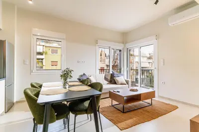 a living room with a couch and a table at Buena Vista by Pame Rentals in Piraeus
