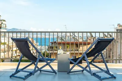 two chairs on a balcony with a view of the ocean at Buena Vista by Pame Rentals in Piraeus