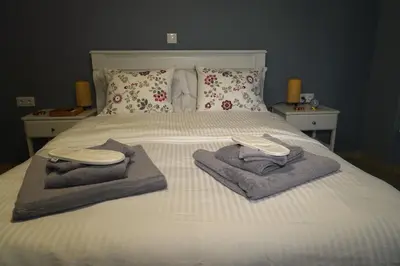 a bed with towels and pillows on it at Urban Maisons Kallithea in Athens