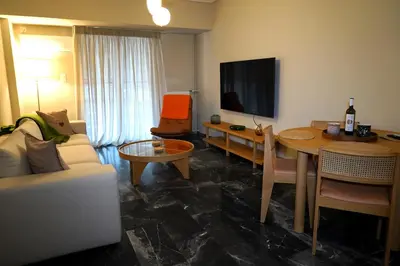 a living room with a couch and a table at Urban Maisons Kallithea in Athens