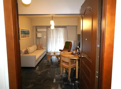 a living room with a couch and a table at Urban Maisons Kallithea in Athens
