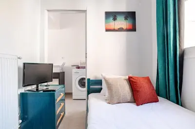 a bedroom with a bed with a tv and a tvicterictericterictericter at Cozy, Convenient & Athens in Athens