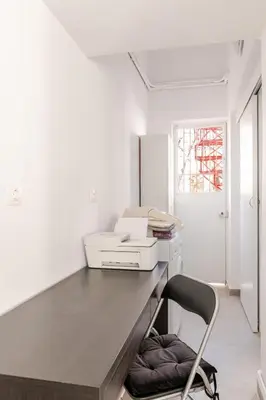 a white kitchen with a desk with a printer at Cozy, Convenient & Athens in Athens