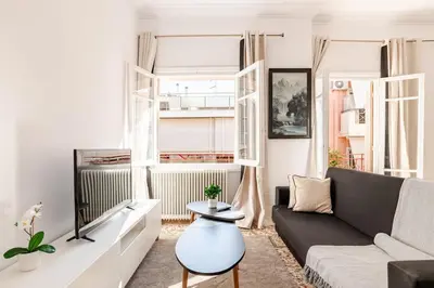 a living room with a couch and a table at Cozy, Convenient & Athens in Athens