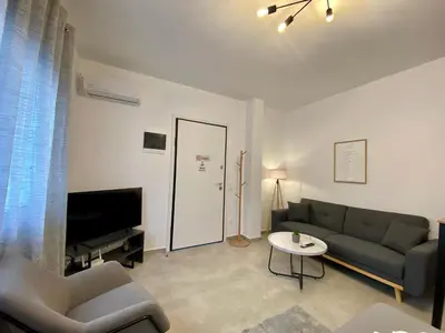 a living room with a couch and a tv at ZEN Residence 1 in Athens