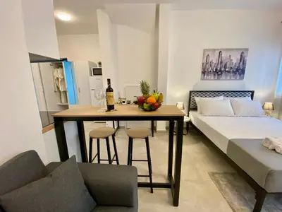 a room with a bed and a table with a bottle of wine at ZEN Residence 1 in Athens