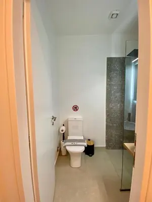 a bathroom with a toilet and a glass shower at ZEN Residence 1 in Athens