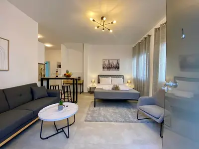 a living room with a couch and a bed and a table at ZEN Residence 1 in Athens