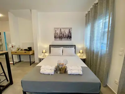 a bedroom with a bed with two towels and a table at ZEN Residence 1 in Athens