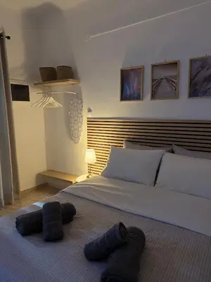 a bedroom with a bed with blue towels on the floor at Sophie's apartment near metro in Athens