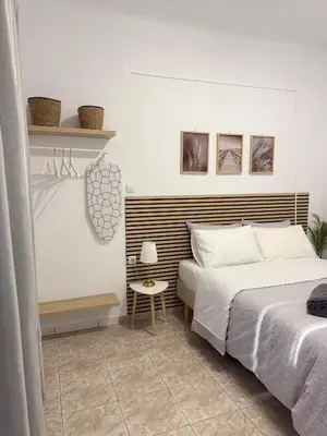 a bedroom with two beds and a table with a lamp at Sophie's apartment near metro in Athens