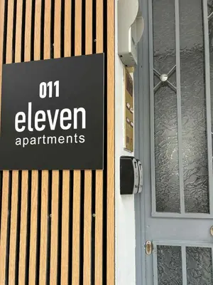 a sign that reads on eleven apartments on a door at Sophie's apartment near metro in Athens