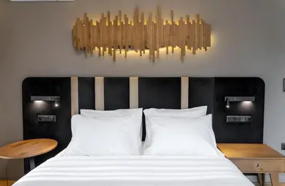 a bedroom with a bed and a chandelier at Acropolis Prime Stay in Athens