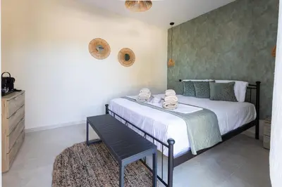 a bedroom with a bed and a bench in it at Villa Keyd Mare in Porto Rafti