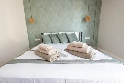 a bedroom with a bed with towels on it at Villa Keyd Mare in Porto Rafti