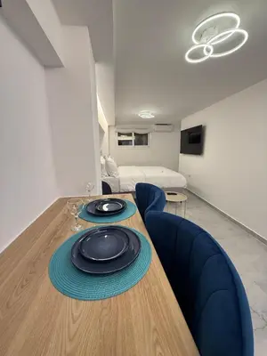 a dining room table with a plate on top of it at City Center Dream Studio in Athens