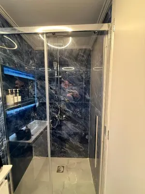 a shower with a glass door in a bathroom at City Center Dream Studio in Athens