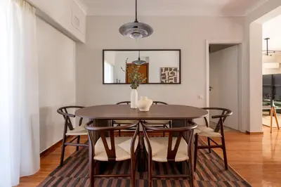 a dining room with a wooden table and chairs at Comfort Living 3BR Apartment in Chalandri by UPSTREET in Athens