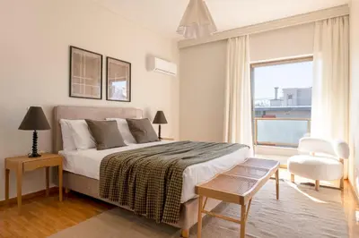 a white bedroom with a bed and a window at Comfort Living 3BR Apartment in Chalandri by UPSTREET in Athens