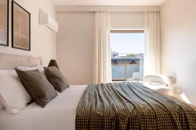 a bedroom with a bed and a large window at Comfort Living 3BR Apartment in Chalandri by UPSTREET in Athens