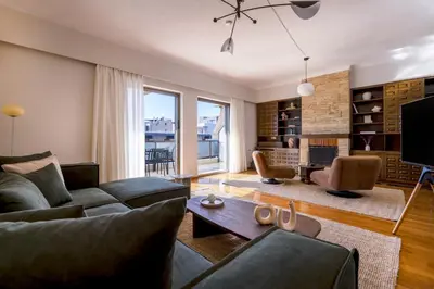 a living room with a couch and a table at Comfort Living 3BR Apartment in Chalandri by UPSTREET in Athens