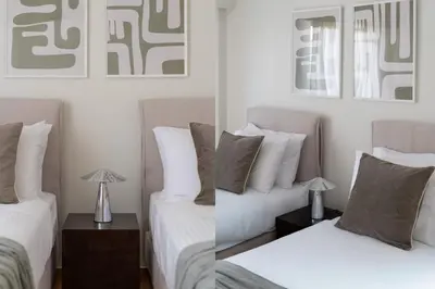 a bedroom with two beds and a lamp on a table at Comfort Living 3BR Apartment in Chalandri by UPSTREET in Athens