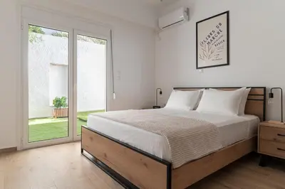a bedroom with a bed and a large window at Athens Urban Vibes 2 Backyard Bliss Patio in Athens