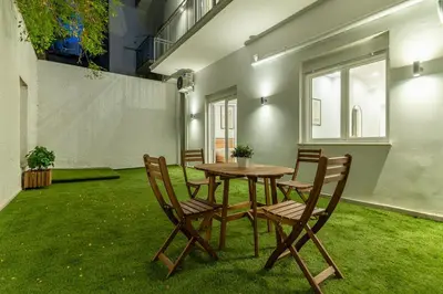 a table and chairs in a room with grass at Athens Urban Vibes 2 Backyard Bliss Patio in Athens