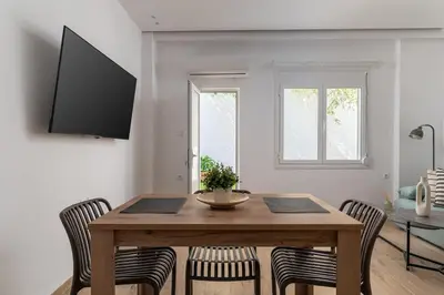 a dining room with a wooden table and chairs at Athens Urban Vibes 2 Backyard Bliss Patio in Athens