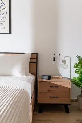 a bedroom with a bed and a nightstand with a plant at Athens Urban Vibes 2 Backyard Bliss Patio in Athens