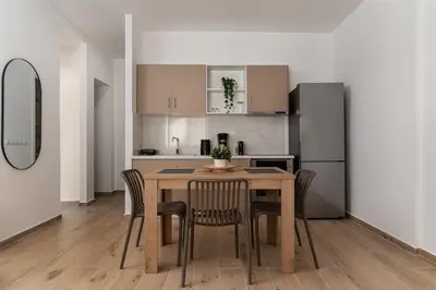 a kitchen and dining room with a table and chairs at Athens Urban Vibes 2 Backyard Bliss Patio in Athens