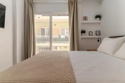 a bedroom with a large bed and a large window at Athens Urban Vibes 3 Bright Front Apt Sunny in Athens