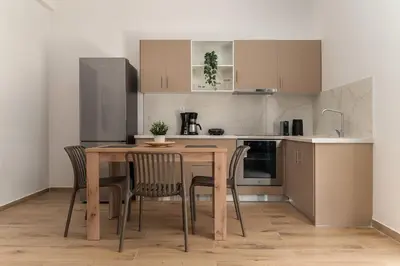 a small kitchen with a wooden table and chairs at Athens Urban Vibes 3 Bright Front Apt Sunny in Athens
