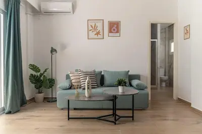 a living room with a blue couch and a table at Athens Urban Vibes 3 Bright Front Apt Sunny in Athens