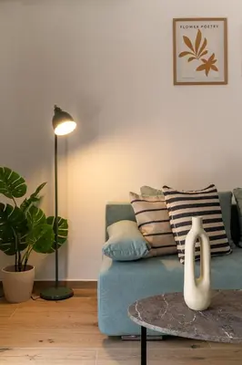 a living room with a blue couch and a table at Athens Urban Vibes 3 Bright Front Apt Sunny in Athens