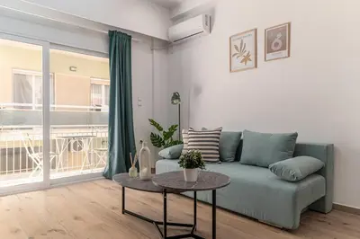 a living room with a blue couch and a table at Athens Urban Vibes 3 Bright Front Apt Sunny in Athens