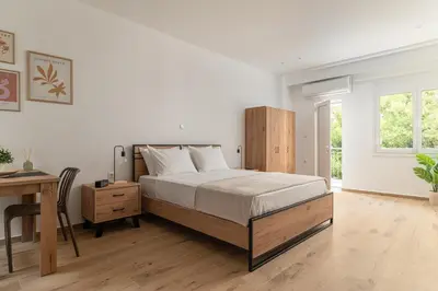 a bedroom with a bed and a desk and a table at Athens Urban Vibes 4 Quiet Balcony Peaceful in Athens