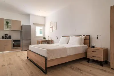 a bedroom with a large bed and a kitchen at Athens Urban Vibes 4 Quiet Balcony Peaceful in Athens