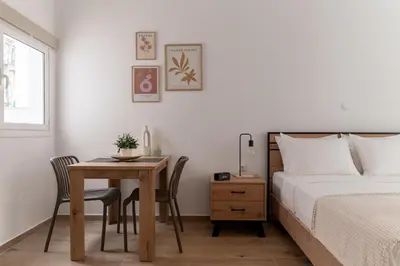 a bedroom with a table and a bed and a table and chairs at Athens Urban Vibes 4 Quiet Balcony Peaceful in Athens