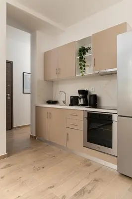 a kitchen with white appliances and wooden floors at Athens Urban Vibes 4 Quiet Balcony Peaceful in Athens