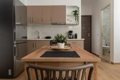 a kitchen with a wooden table with a potted plant on it at Athens Urban Vibes 5 Cozy Balcony Renovated in Athens