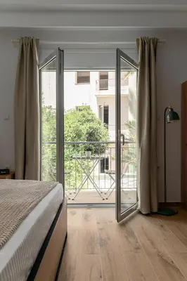 a bedroom with a bed and a sliding glass door at Athens Urban Vibes 5 Cozy Balcony Renovated in Athens