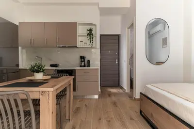 a kitchen with a table and a bed in a room at Athens Urban Vibes 5 Cozy Balcony Renovated in Athens